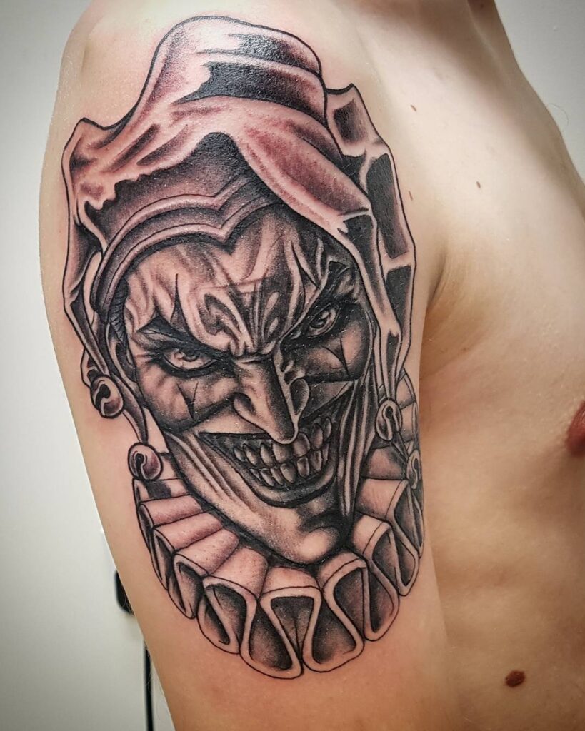 Tattoo of a jester on the shoulder for men