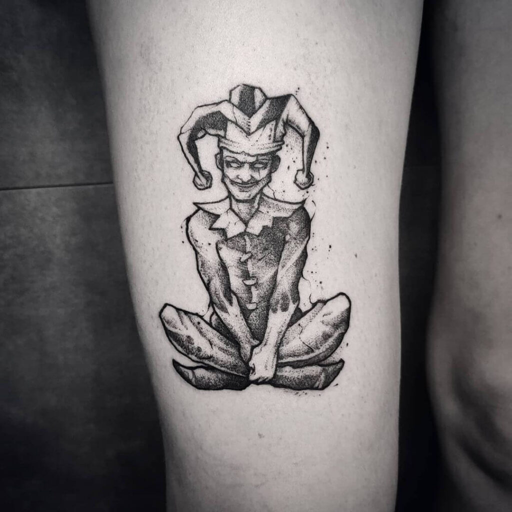 Tattoo of a jester on the thigh for women