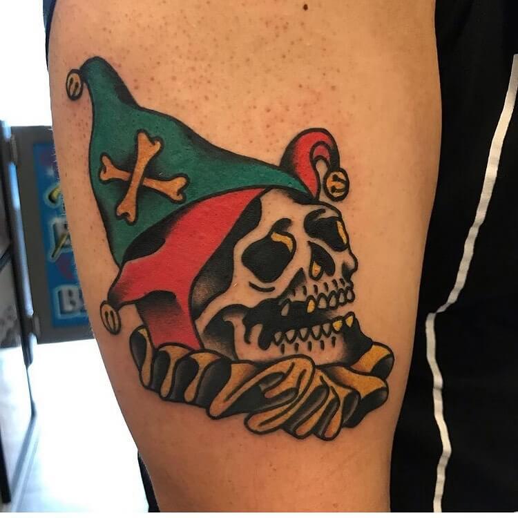 Tattoo of a jester on the shoulder for men