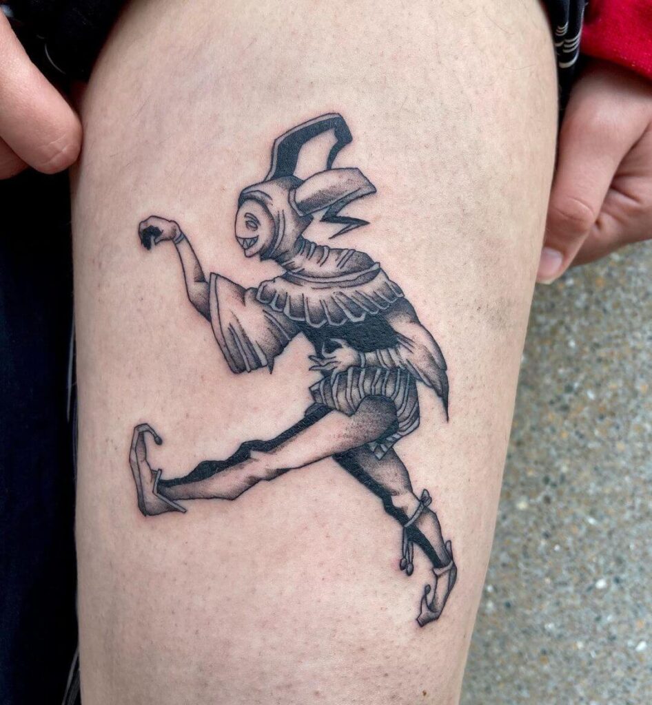 Tattoo of a jester on the thigh for women