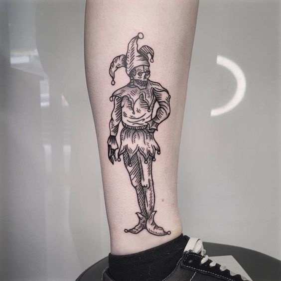 Tattoo of a jester on the shin for men