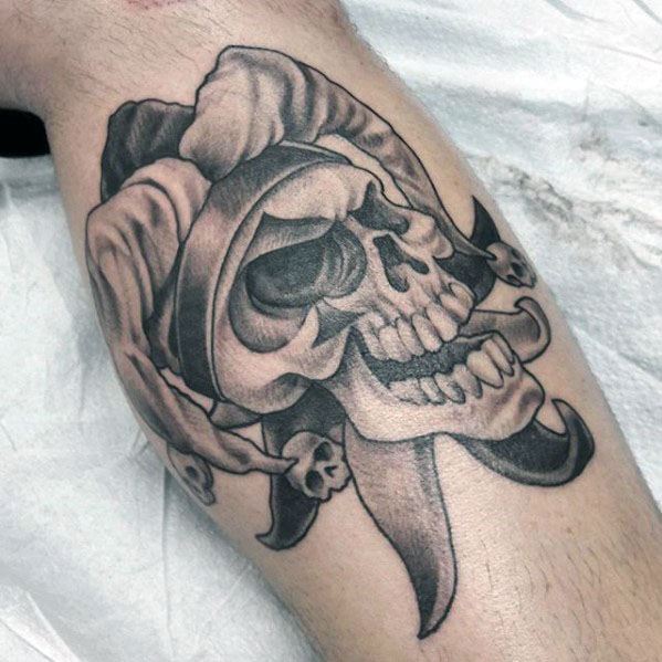 Tattoo of a jester on the shin for men