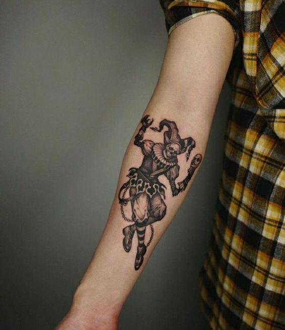 Tattoo of a jester on the forearm for women