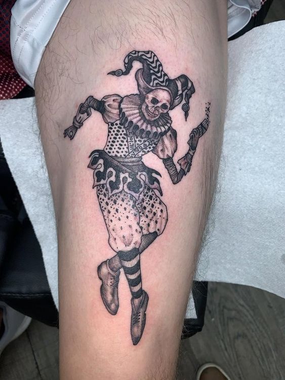 Tattoo of a jester on the thigh for men