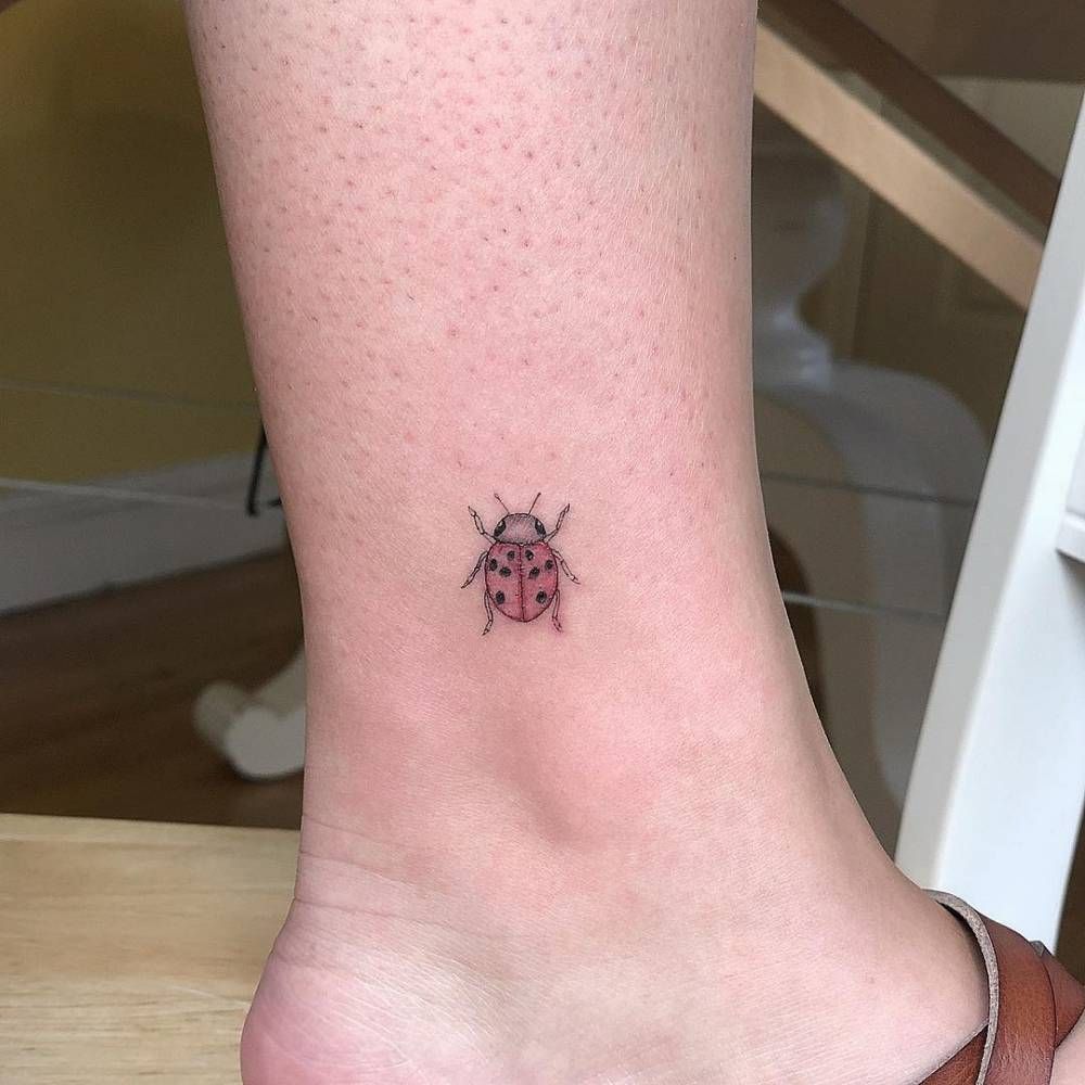 Ladybug tattoo on the shin for women