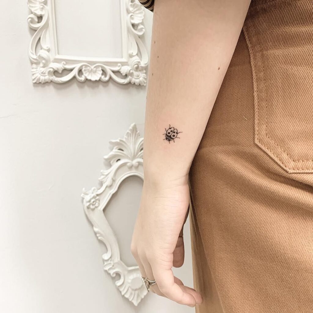 Ladybug tattoo on forearm for women