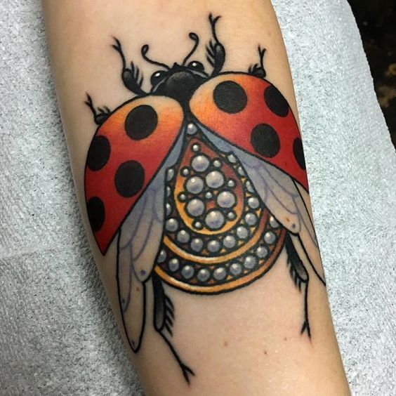 Ladybug tattoo on forearm for women