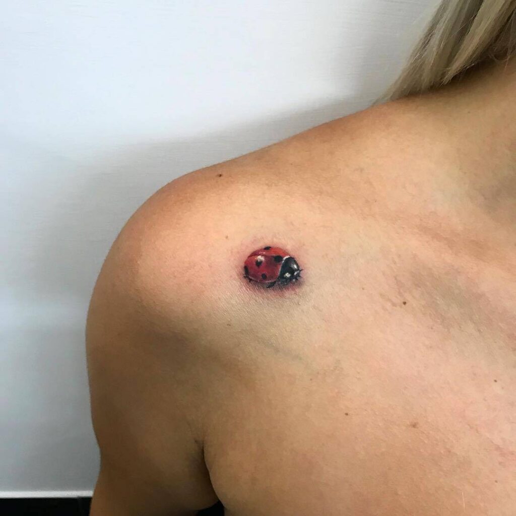 Ladybug tattoo on the shoulder for women