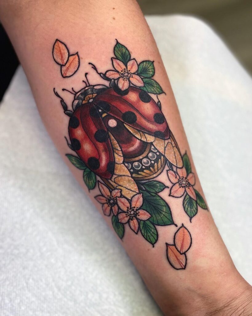 Ladybug tattoo on forearm for women