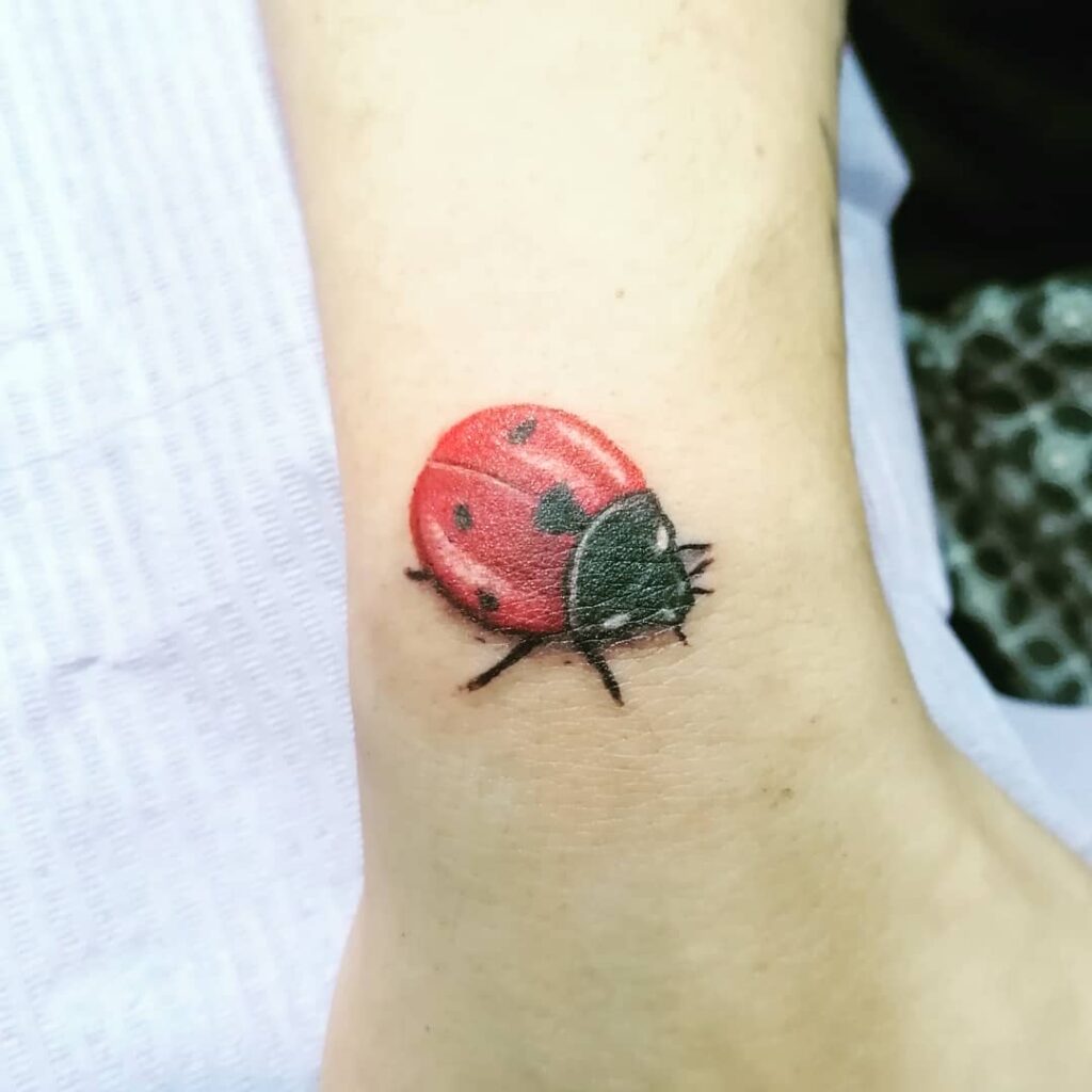 Ladybug tattoo on ankle for women