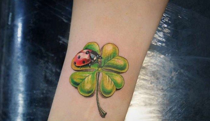 Ladybug tattoo on the arm for women