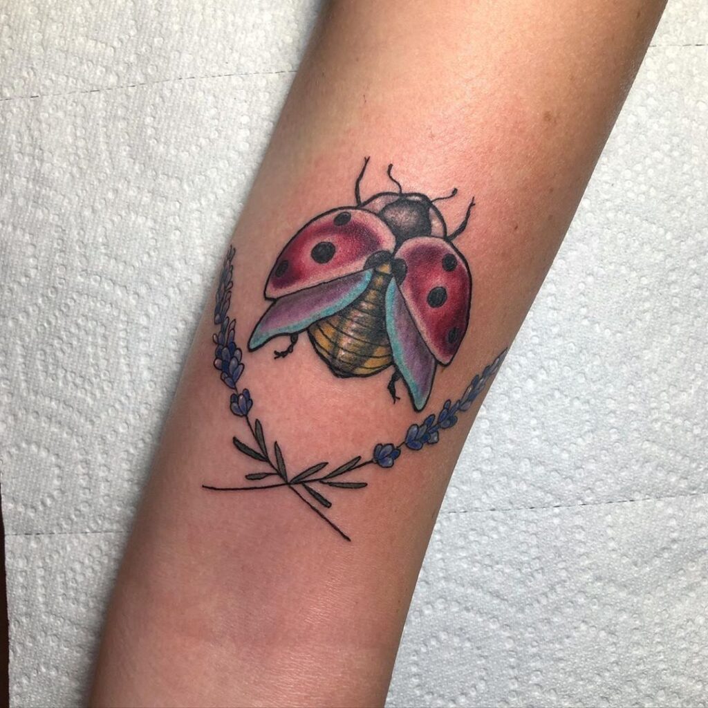 Ladybug tattoo on the shoulder for women