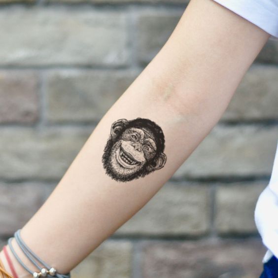 Monkey tattoo on the forearm for women