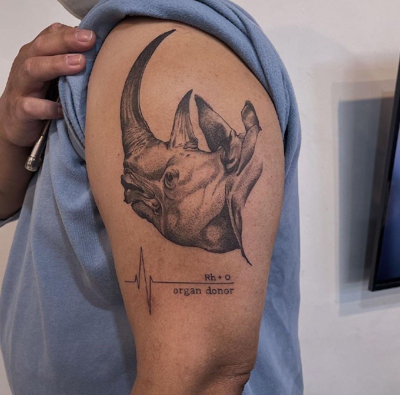 Rhinoceros tattoo on the shoulder for men