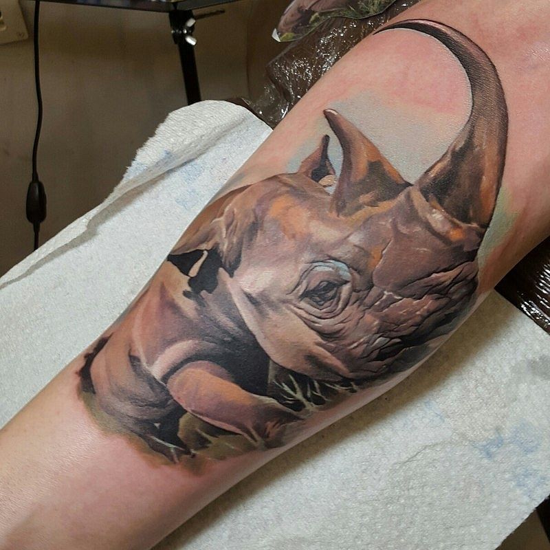 Rhinoceros tattoo on the arm for women