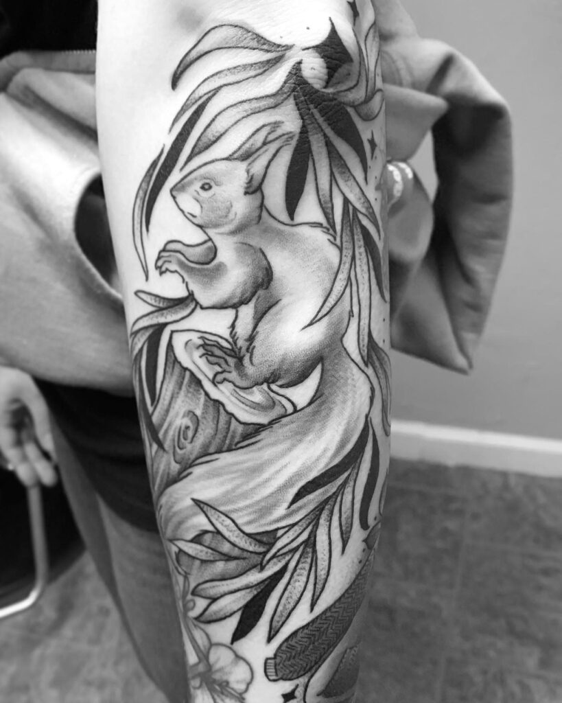 Tattoo of a squirrel on the arm for women