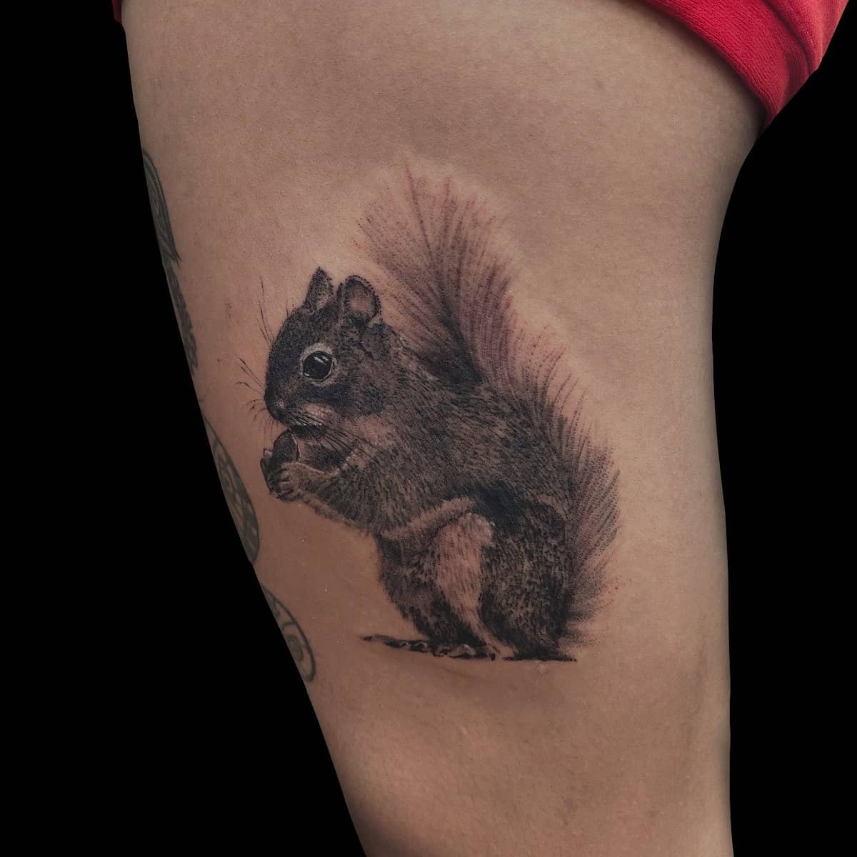 Squirrel thigh tattoo on leg