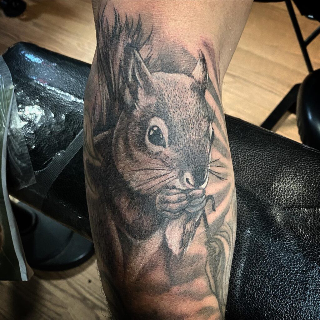 Tattoo of a squirrel on the arm for men