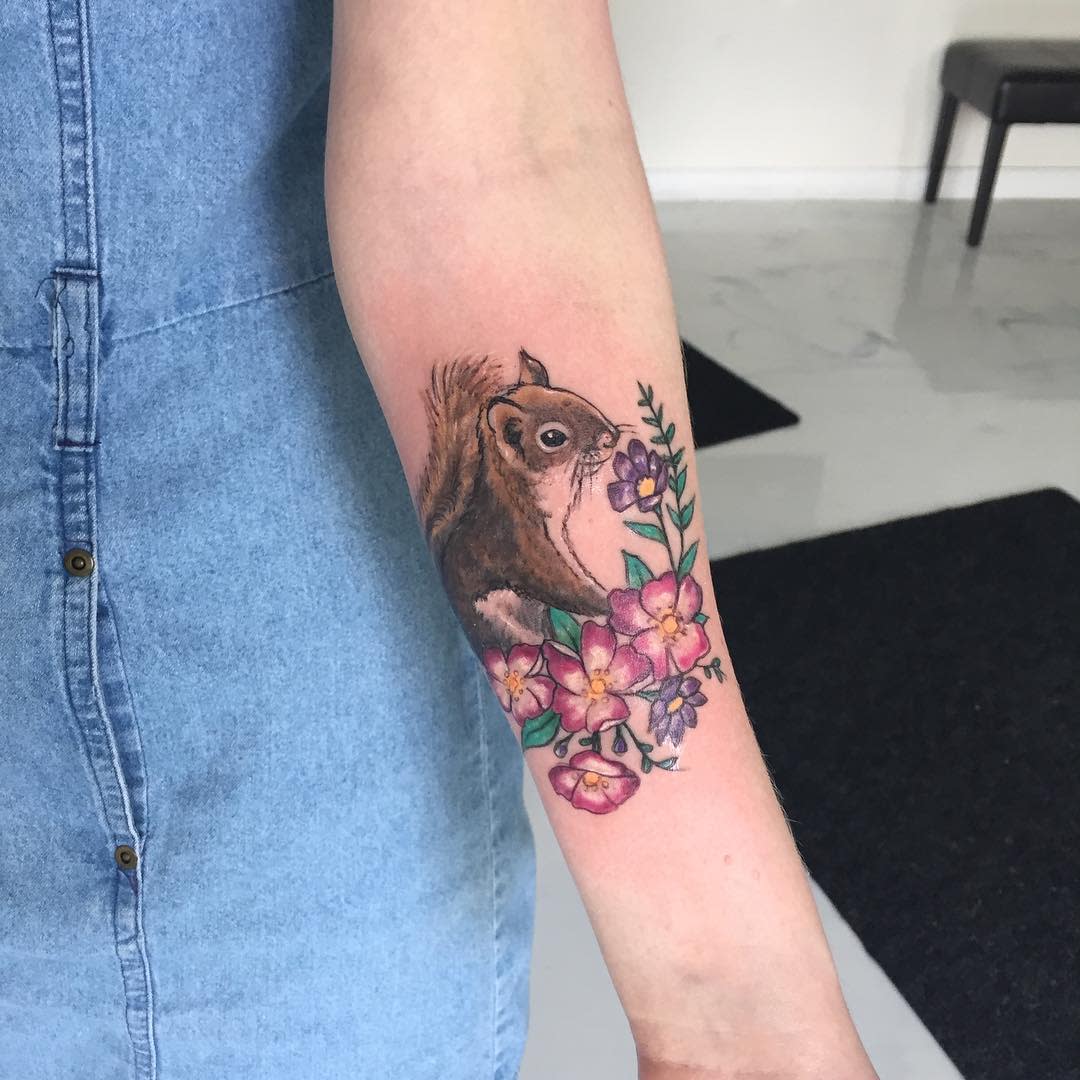 A squirrel tattoo on the forearm for women