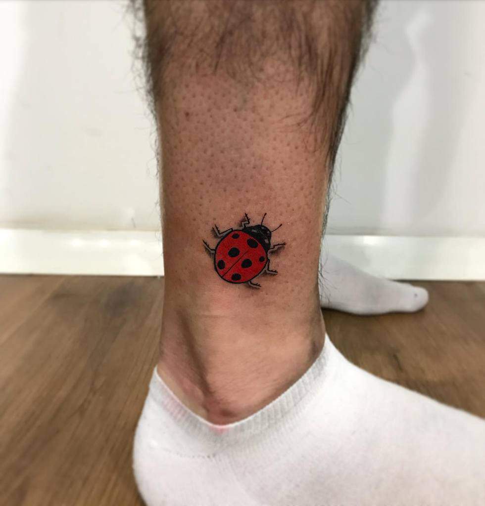 Ladybug tattoo on the shin for men