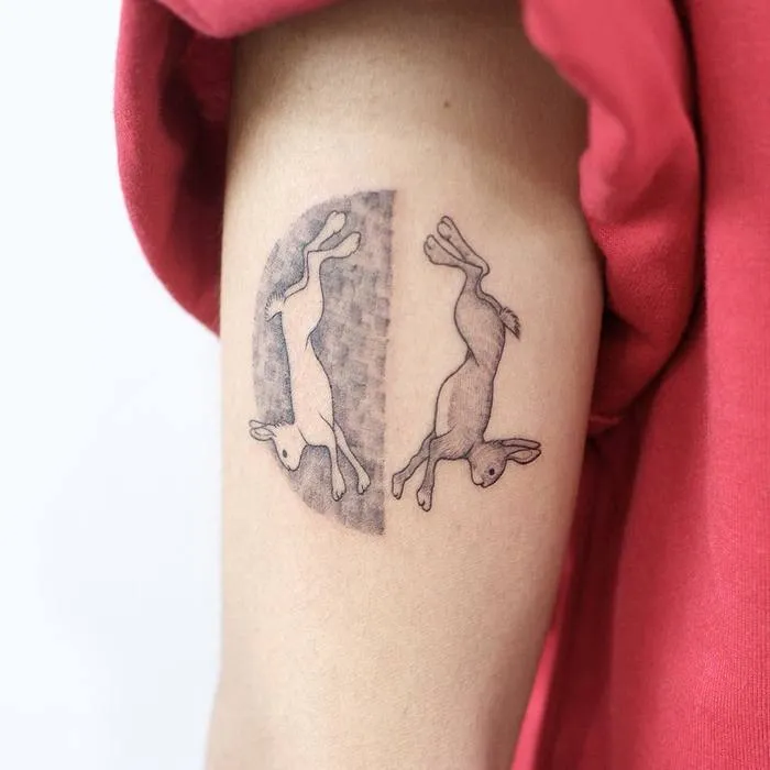 Tattoo of a hare (rabbit) on the shoulder for women