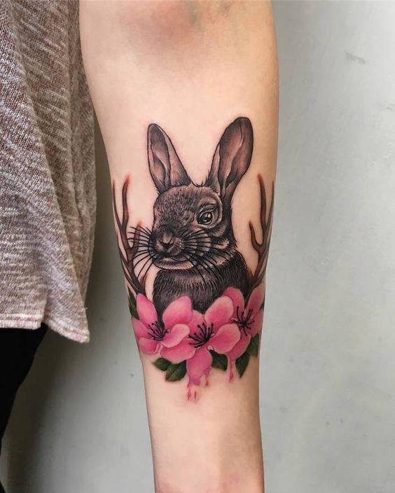 Tattoo of a hare (rabbit) on the forearm for women