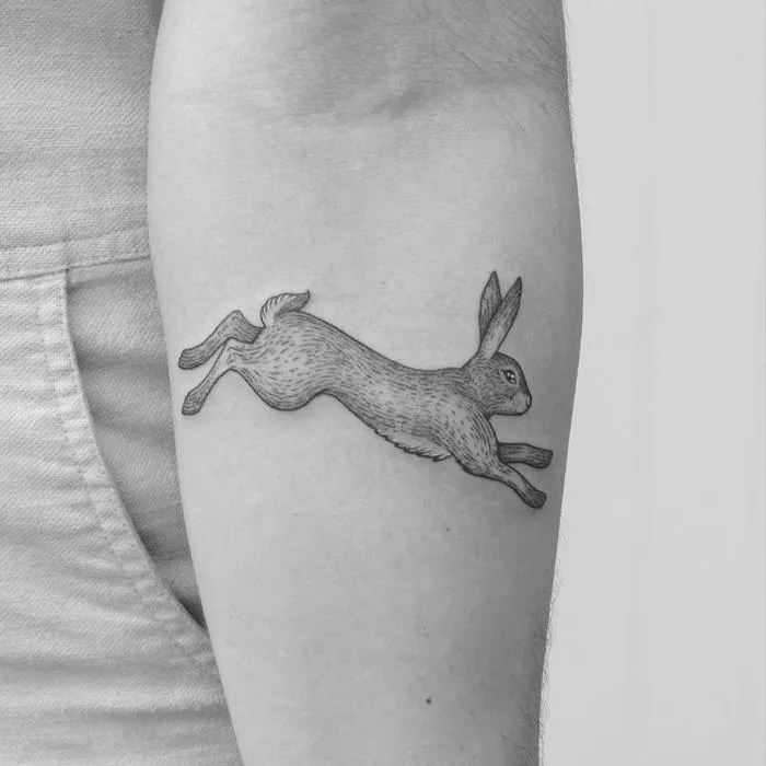 Tattoo of a hare (rabbit) on the forearm for women