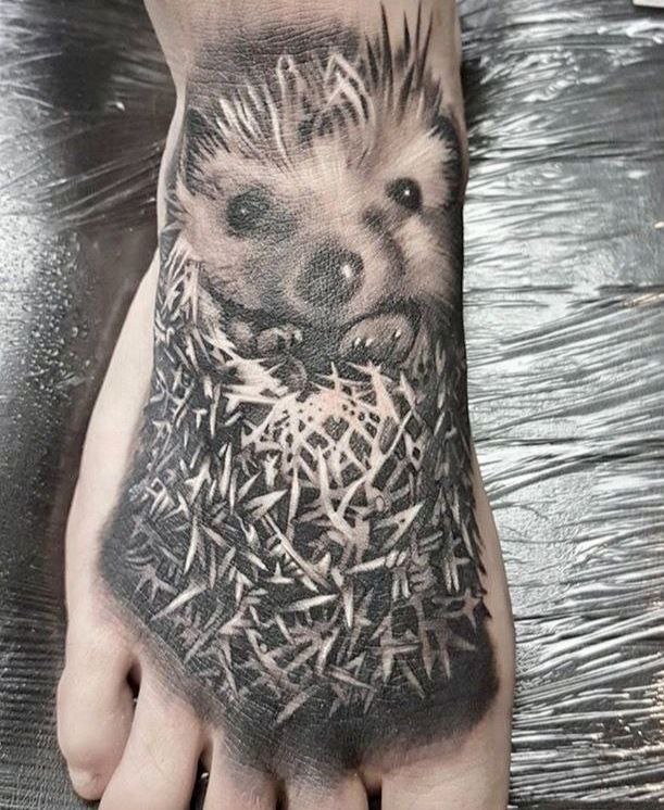 Tattoo of a hedgehog on the ankle for men