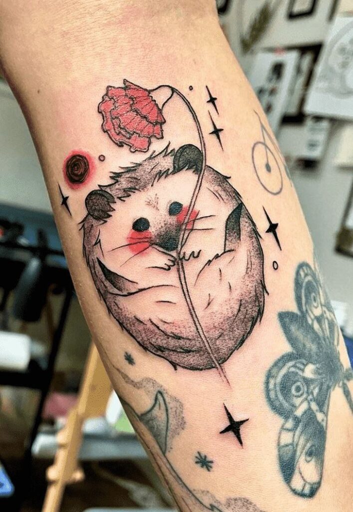 Tattoo of a hedgehog on the arm for women