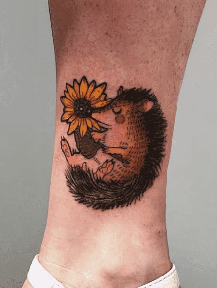 Tattoo of a hedgehog on the shin for men