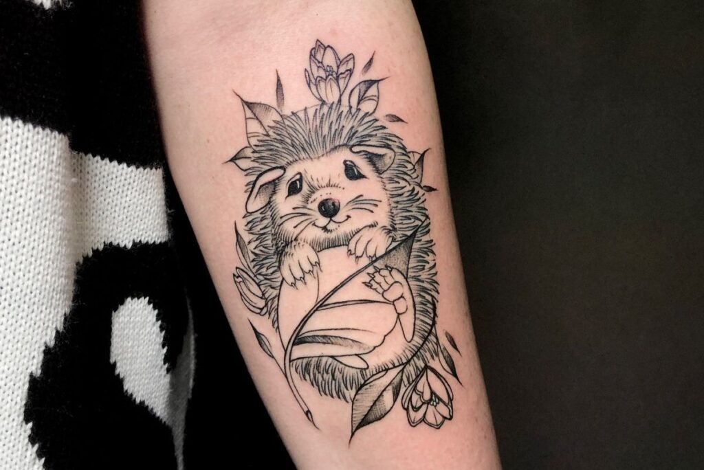 Tattoo of a hedgehog on the forearm for women