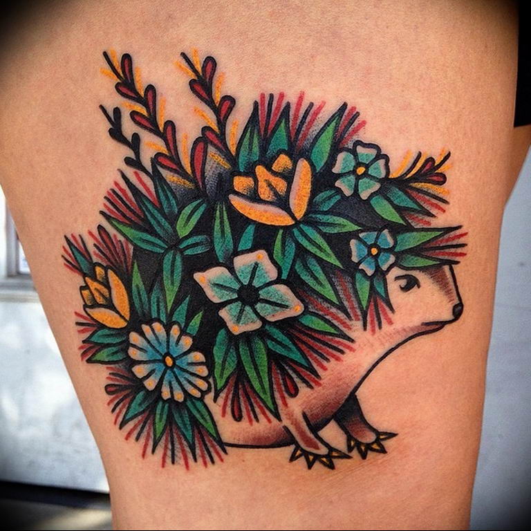 Tattoo of a hedgehog on the hip for women