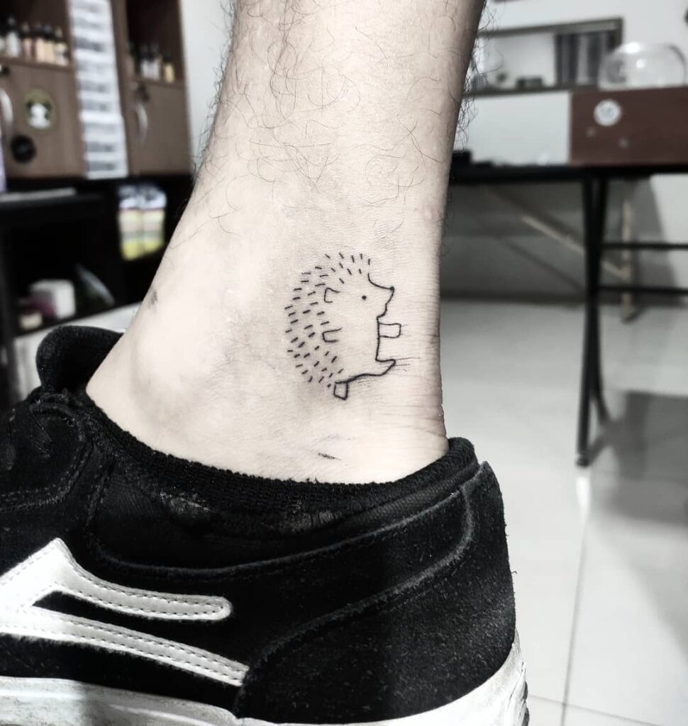 Tattoo of a hedgehog on the ankle for men