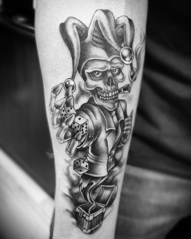 Tattoo of a jester on the arm for men