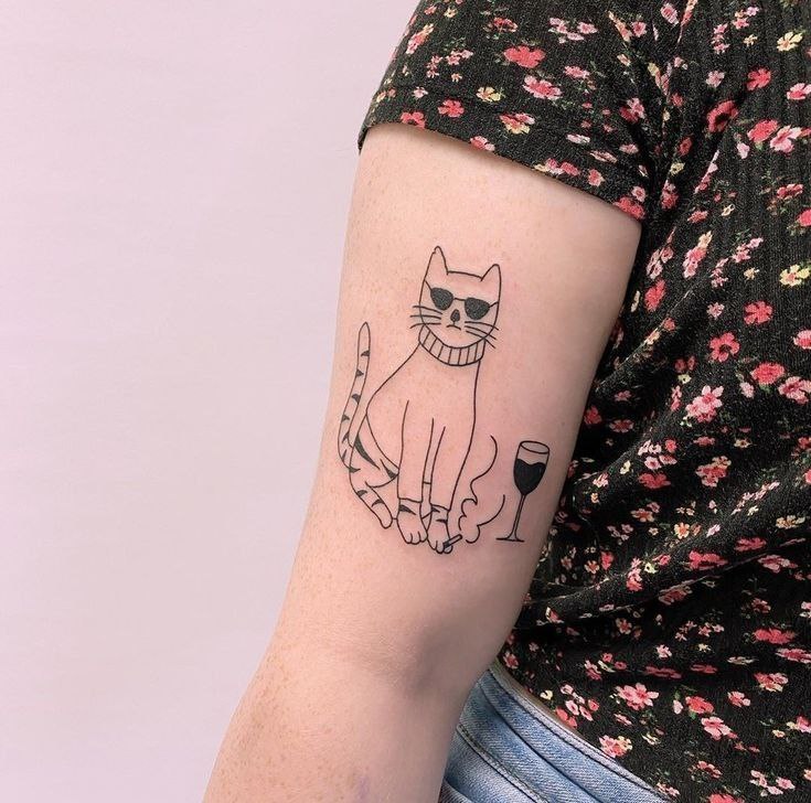 Cat tattoo on the shoulder for women