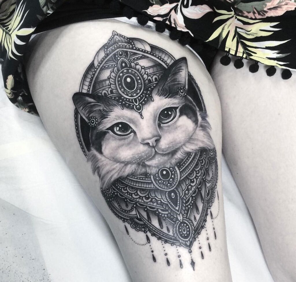 Cat tattoo on the thigh for women