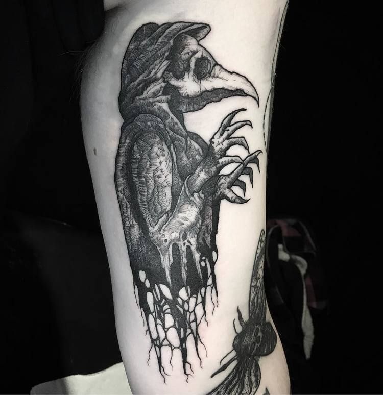 Plague doctor tattoo on the biceps for men