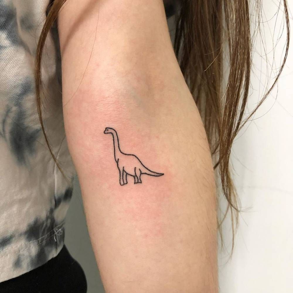 Tattoo of a dinosaur on the forearm for women