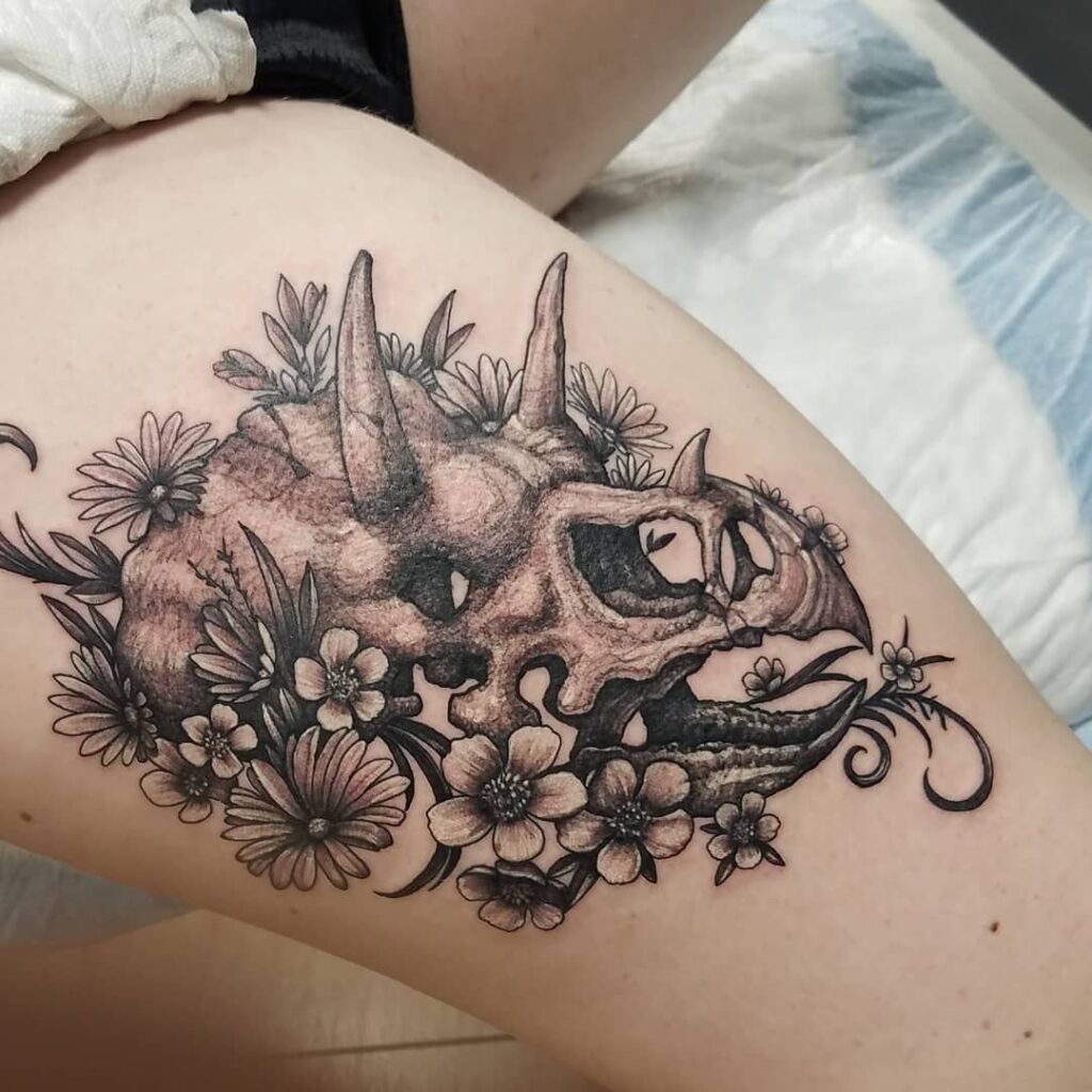 Dinosaur tattoo on the hip for women