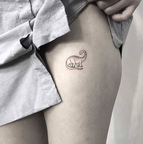 Dinosaur tattoo on the hip for women