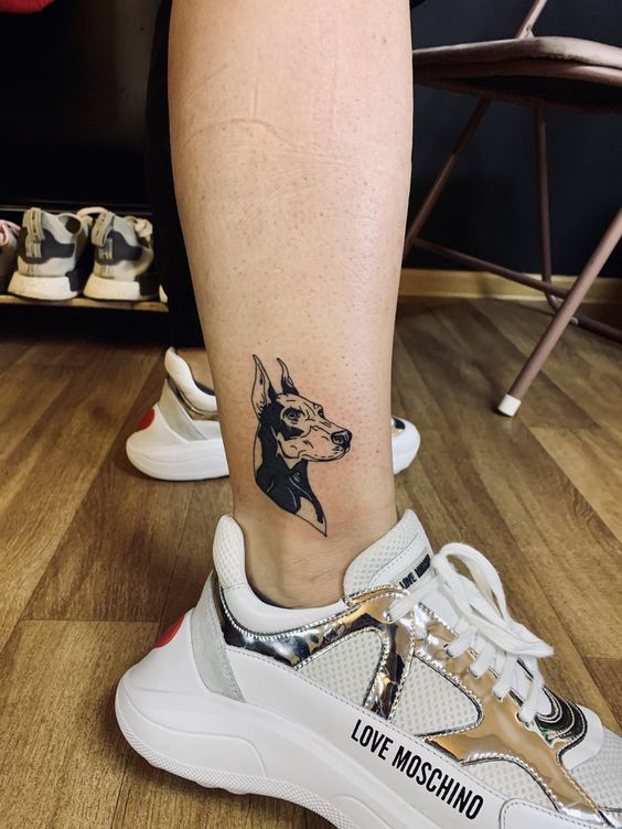 Doberman tattoo on the leg for women