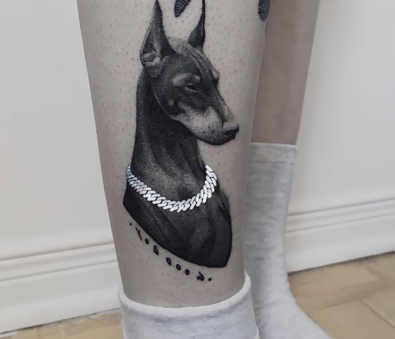 Doberman tattoo on the shin for women