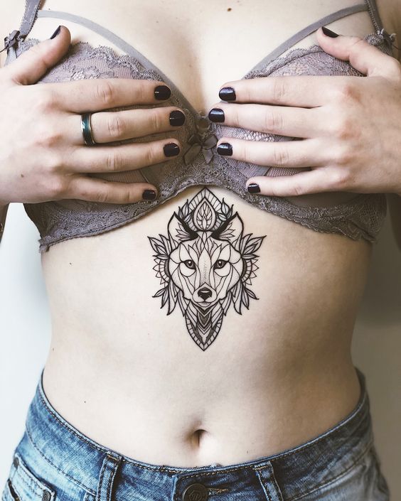 Tattoo of a wolf on the stomach for women