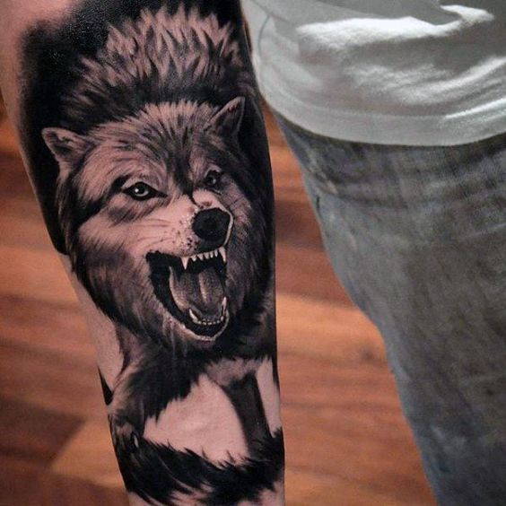 Tattoo of a wolf on the forearm for men