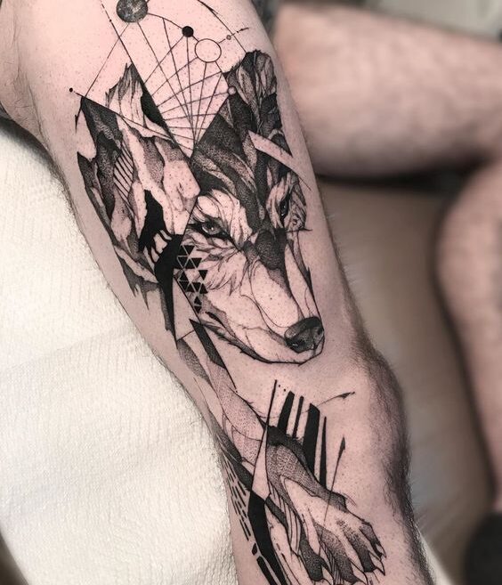 Tattoo of a wolf on the leg for men