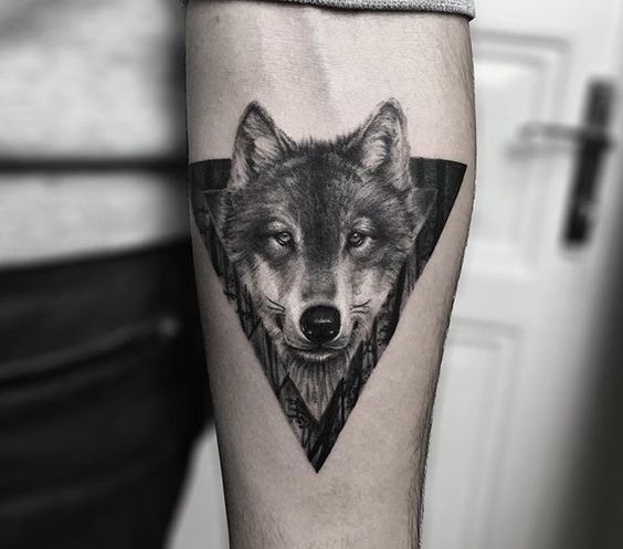 Tattoo of a wolf on the forearm for men