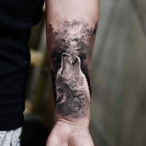 Tattoo of a wolf on the forearm for men