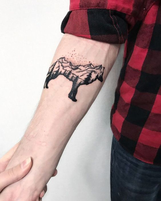 Tattoo of a wolf on the forearm for men