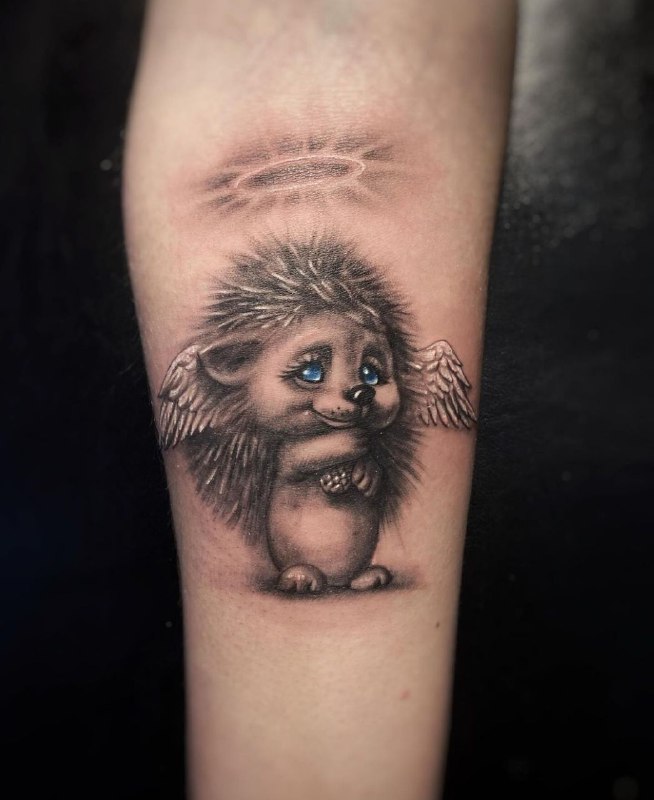 Tattoo of a hedgehog on the forearm for women