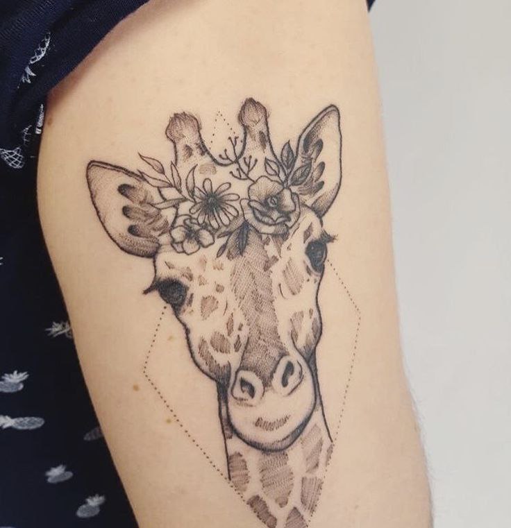 Tattoo of a giraffe on the shoulder for women